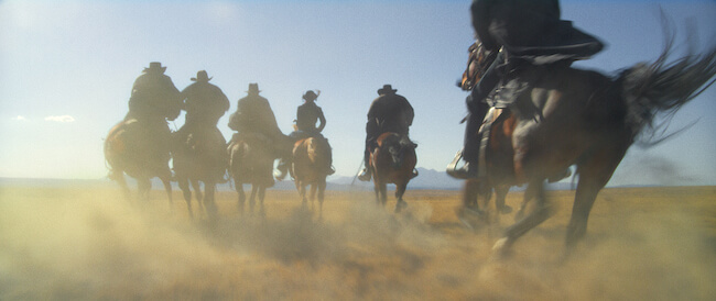 people on horses riding away